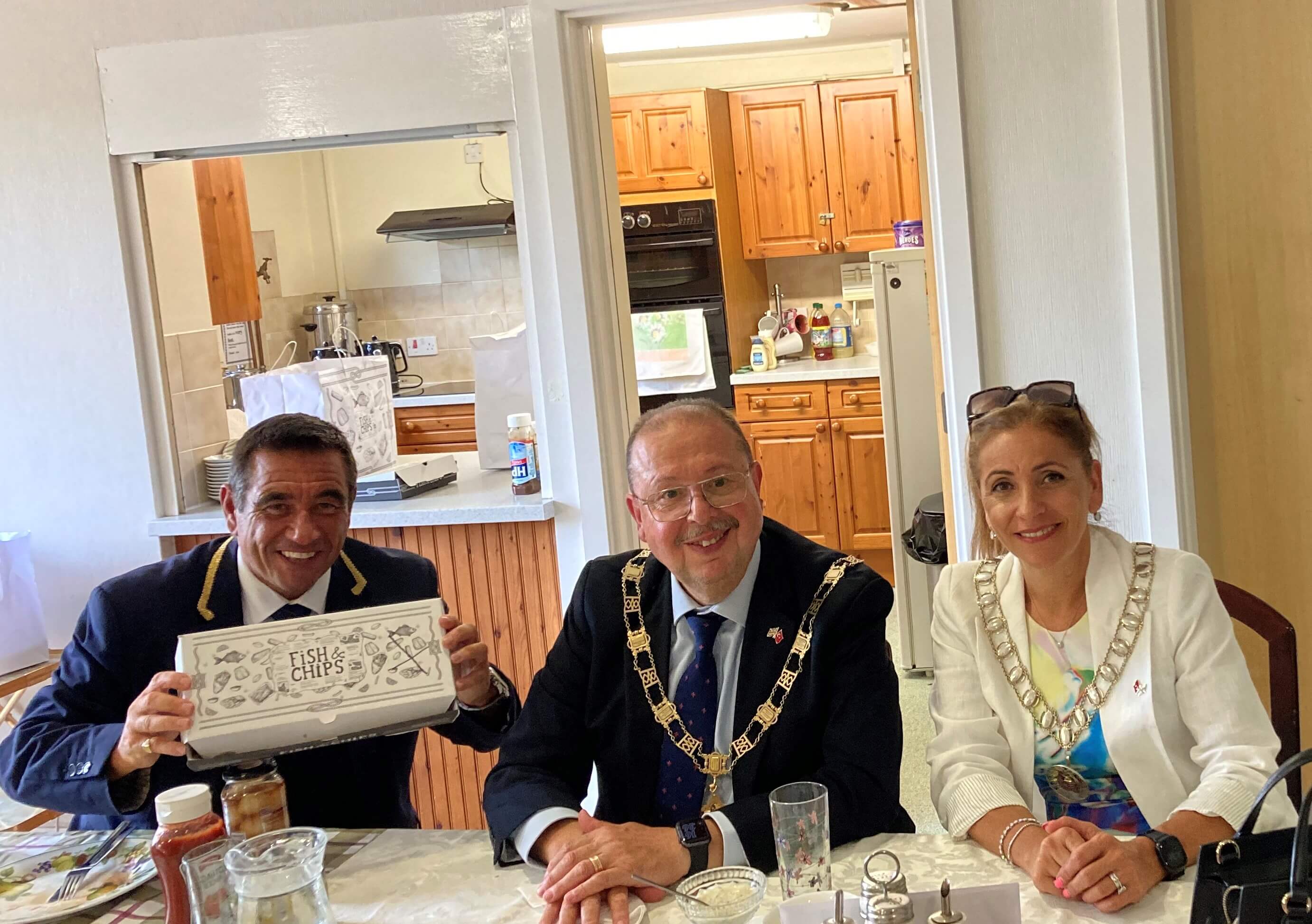 The mayor and mayoress eating in a independent living scheme fish and chips